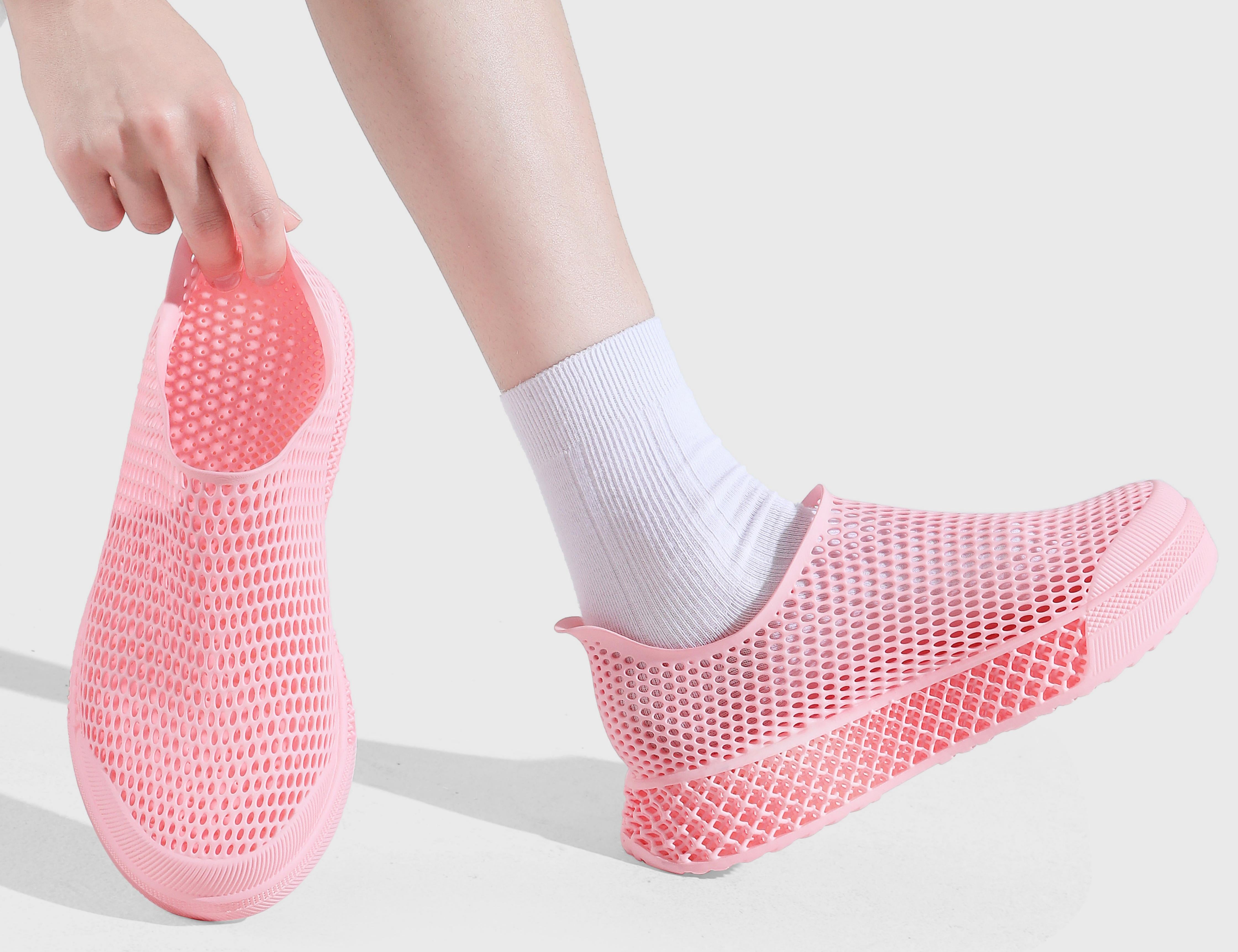 Pink 3d printed sneaker being worn with a white background