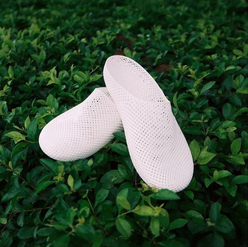 Nexbie white 3d printed slippers on green foliage