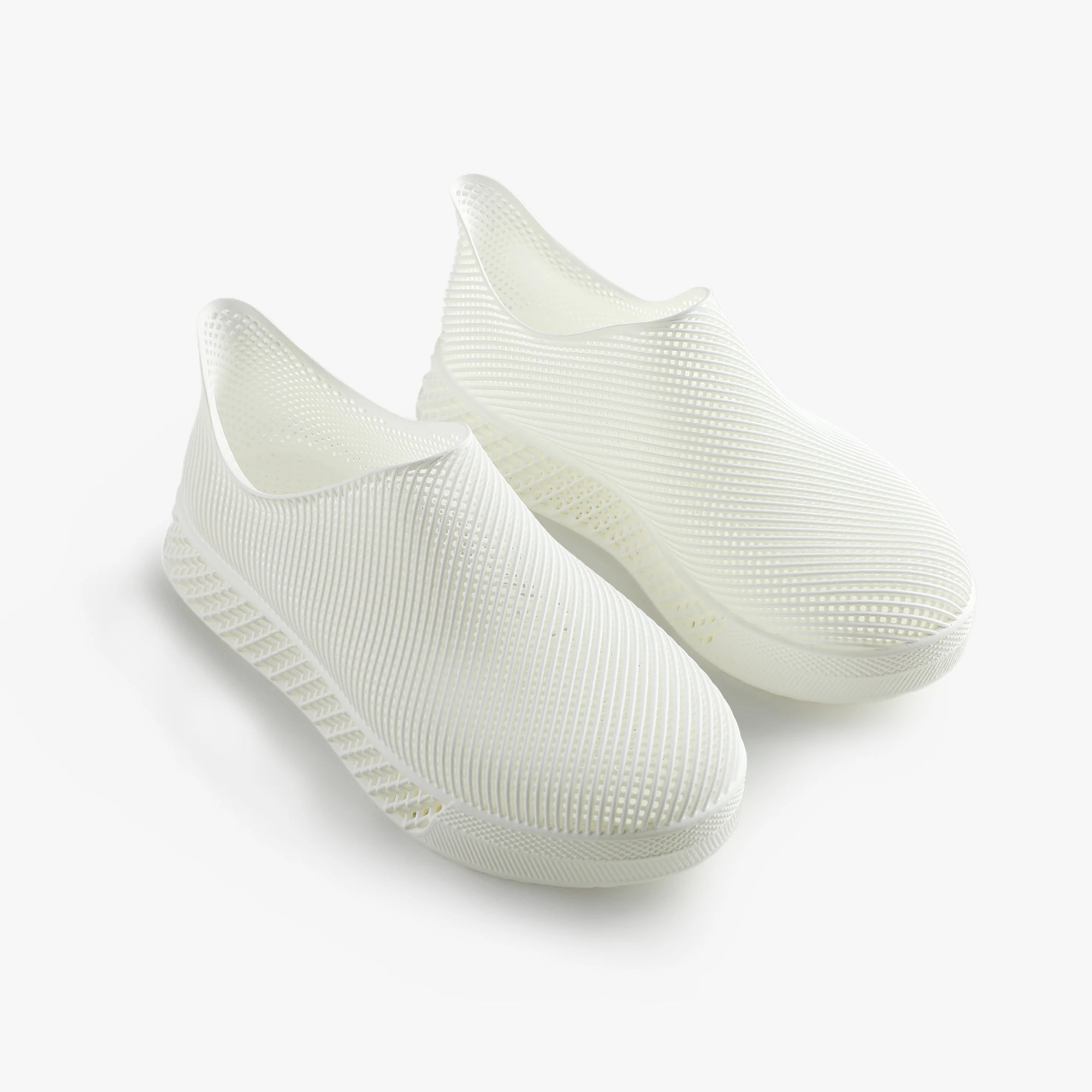 Pair of white 3d printed shoes on a light gray background