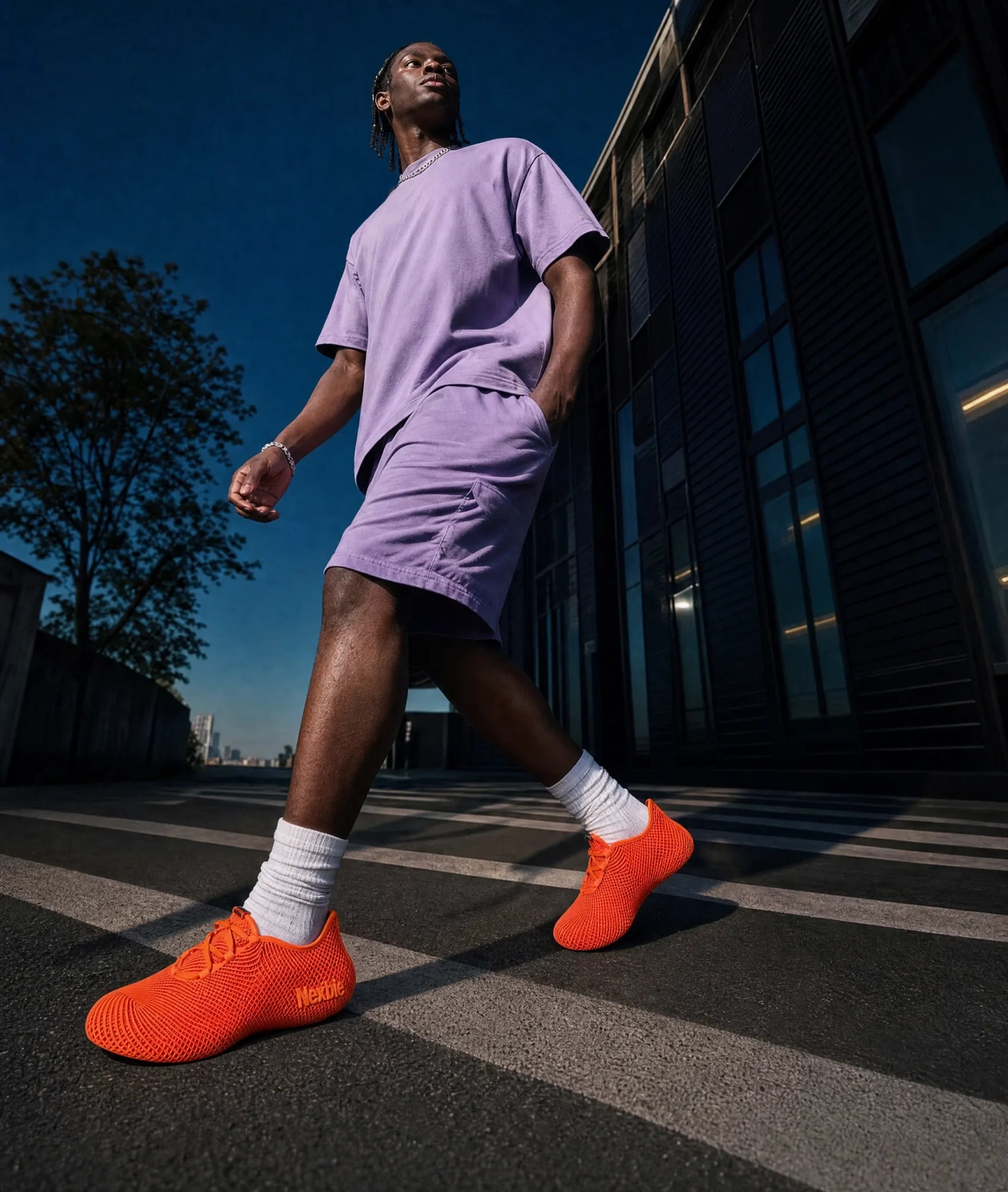 Man walking on a city sidewalk wearing Aeroraise sneakers