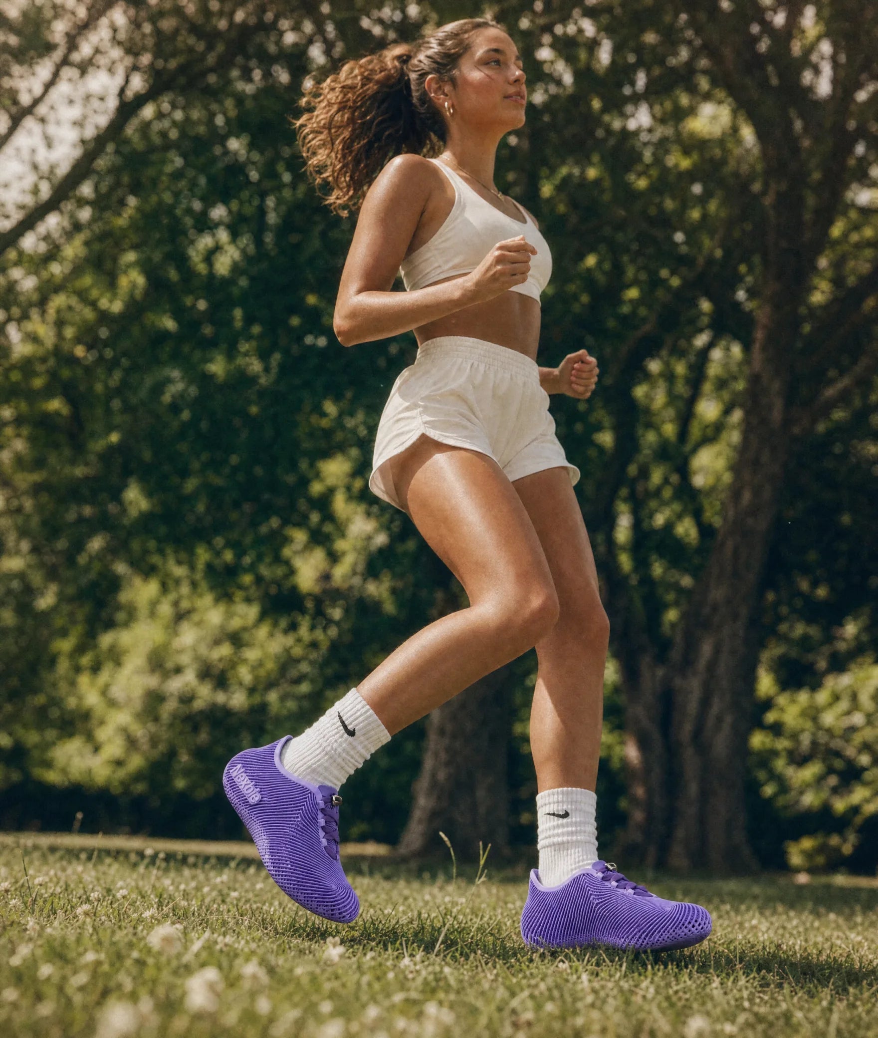 Woman jogging outdoors in purple Aeroraise sneakers
